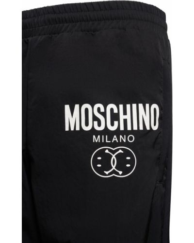 Bavlnené teplákové nohavice s potlačou Moschino čierna
