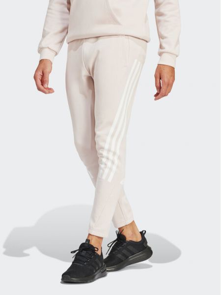 Pruhované slim fit priliehavé teplákové nohavice Adidas ružová