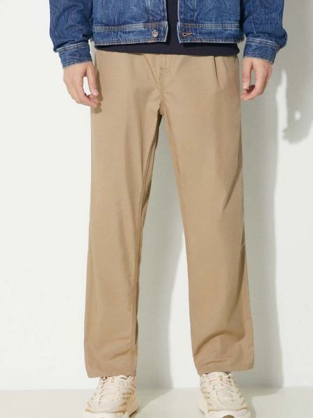 Jednobarevné bavlněné kalhoty Carhartt Wip béžové