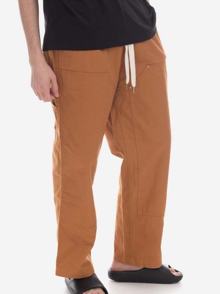 Jednobarevné bavlněné kalhoty Puma béžové