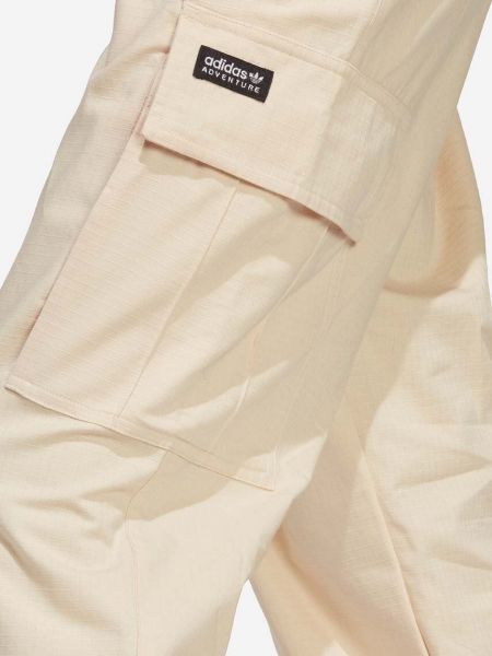 Jednobarevné bavlněné kalhoty Adidas Originals béžové
