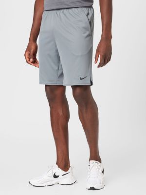 Teplákové nohavice Nike sivá
