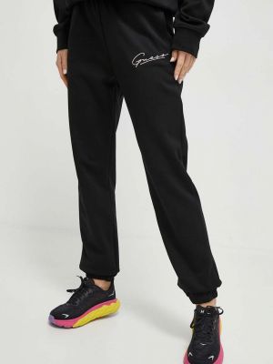 Sportovní kalhoty s aplikacemi Guess černé