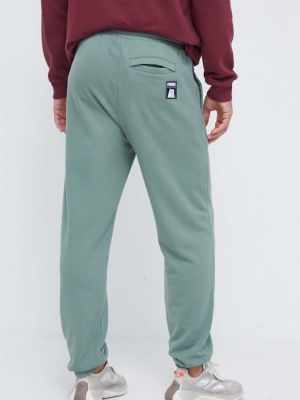 Bavlněné sportovní kalhoty s potiskem Puma zelené