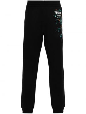 Pantaloni di cotone con stampa Moschino nero