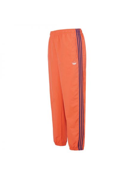 Плетеные спортивные штаны в полоску Adidas оранжевые
