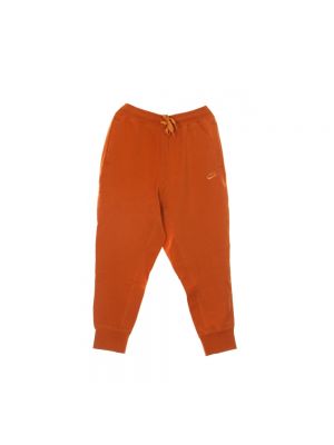 Spodnie sportowe Nike pomarańczowe