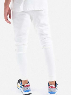 Bavlněné sportovní kalhoty s aplikacemi Alpha Industries bílé