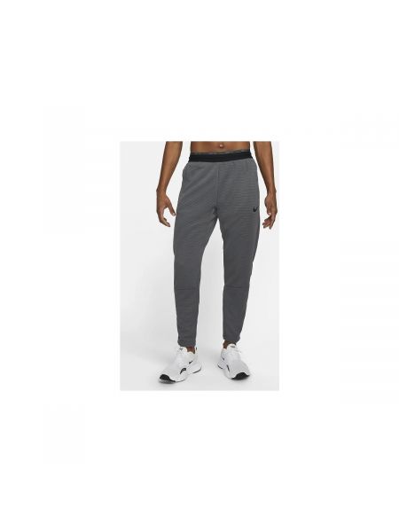 Fleecové nohavice Nike sivá
