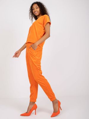 Velurové sportovní kalhoty s výstřihem do v Fashionhunters oranžové