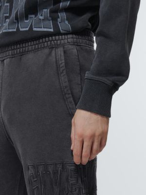 Džerzej bavlnené teplákové nohavice s potlačou Givenchy čierna