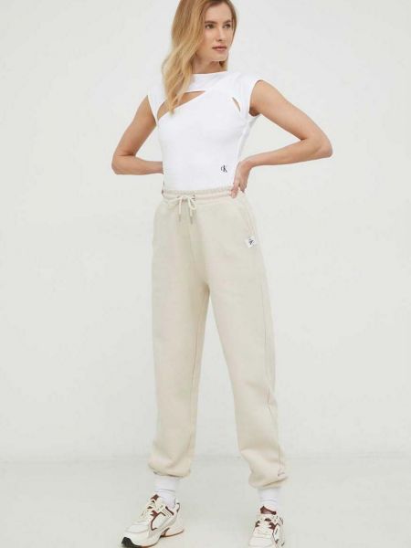 Spodnie sportowe bawełniane Calvin Klein Jeans beżowe