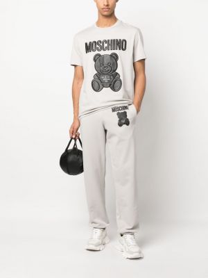 Bavlněné sportovní kalhoty s potiskem Moschino šedé