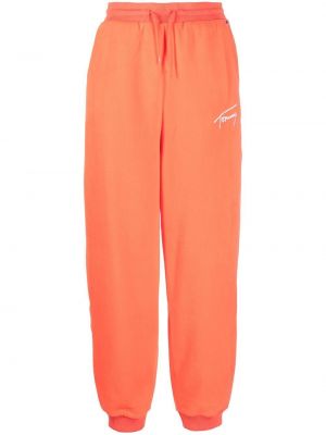 Haftowane spodnie sportowe Tommy Jeans pomarańczowe