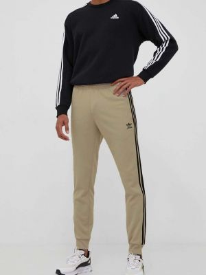 Sportovní kalhoty s aplikacemi Adidas Originals béžové