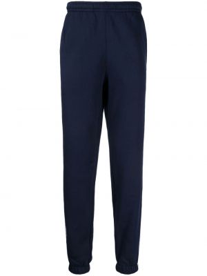 Памучни спортни панталони на райета Lacoste синьо