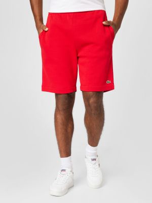 Teplákové nohavice Lacoste červená