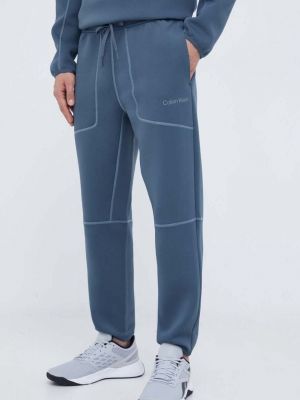 Kalhoty s aplikacemi Calvin Klein Performance šedé
