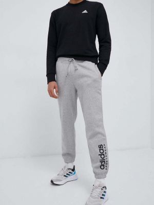 Sportovní kalhoty s potiskem Adidas šedé
