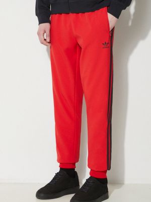 Спортивні штани з аплікацією Adidas Originals червоні