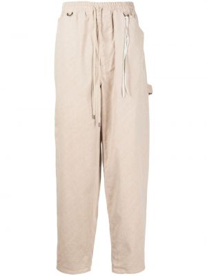 Bavlnené teplákové nohavice s potlačou Mastermind Japan béžová