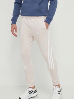 Spodnie sportowe z nadrukiem Adidas różowe