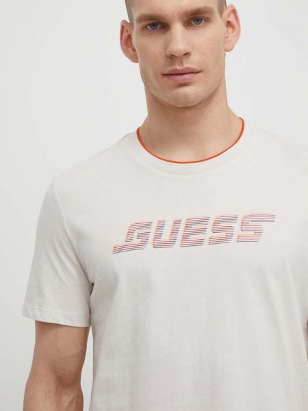 Koszulka bawełniana z nadrukiem Guess beżowa