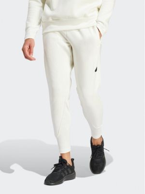 Priliehavé teplákové nohavice Adidas biela