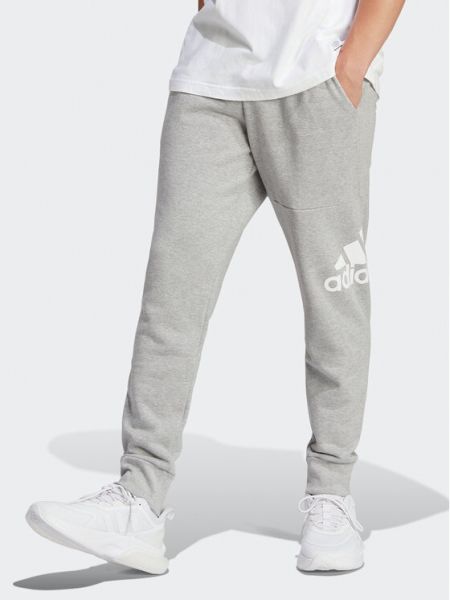 Priliehavé teplákové nohavice Adidas sivá