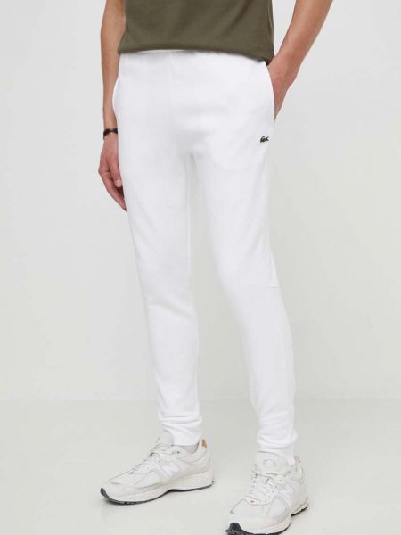 Białe spodnie sportowe Lacoste