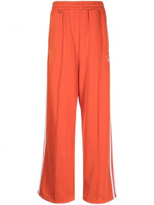 Pruhované teplákové nohavice s výšivkou Doublet oranžová