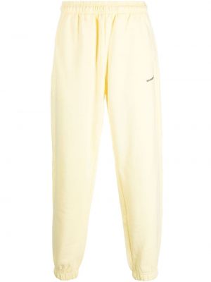 Spodnie sportowe bawełniane w jednolitym kolorze Monochrome żółte