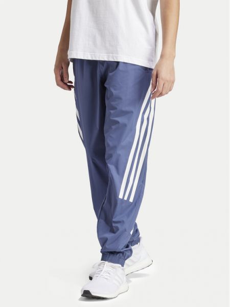 Pruhované slim fit priliehavé teplákové nohavice Adidas modrá