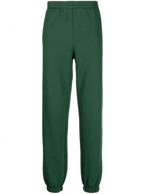 Bavlnené teplákové nohavice Lacoste zelená