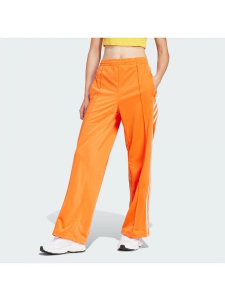 Spodnie sportowe relaxed fit Adidas pomarańczowe
