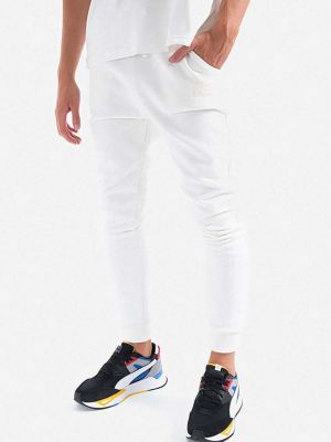 Bavlněné sportovní kalhoty s aplikacemi Alpha Industries bílé