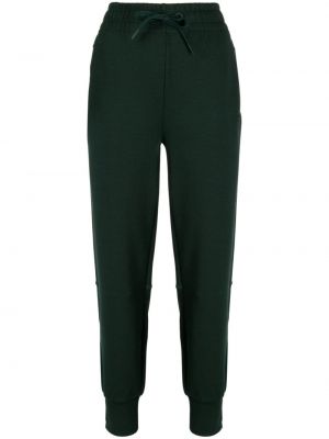 Bavlnené teplákové nohavice s potlačou Lacoste zelená