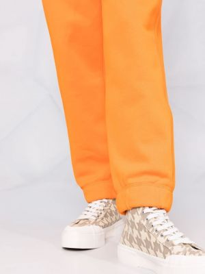 Sportovní kalhoty s výšivkou Ganni oranžové