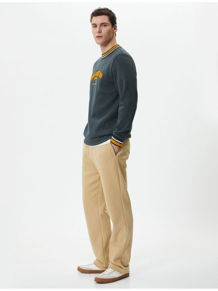 Sportovní kalhoty s výšivkou s kapsami Koton