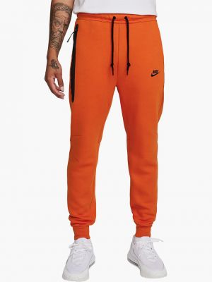 Флисовые джоггеры Nike оранжевые
