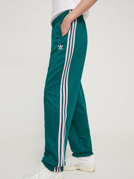 Sportovní kalhoty s aplikacemi Adidas Originals zelené