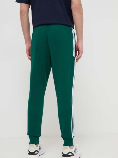 Bavlněné sportovní kalhoty s aplikacemi Adidas zelené