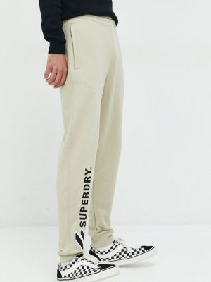 Bavlněné sportovní kalhoty s aplikacemi Superdry béžové
