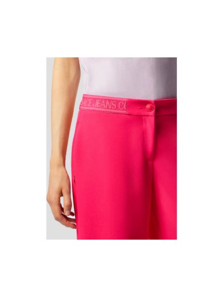 Spodnie relaxed fit Versace Jeans Couture różowe